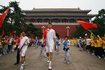 BEIJING - AUGUST 06:  China's NBA star Yao Ming carries the Olympic torch before the start of the Olympic torch relay on Tiananmen Square on August 6, 2008 in Beijing, China.  (Photo by Feng Li/Getty Images)