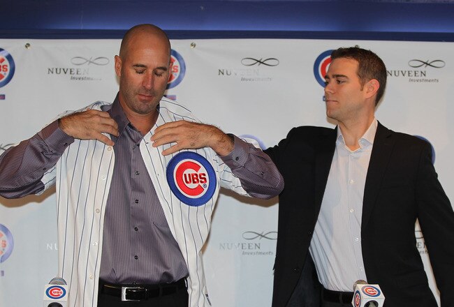 CHICAGO, IL - NOVEMBER 18:  President Theo Epstein of the Chicago Cubs helps new manager Dale Sveum with his jersey during a press conference at Wrigley Field on November 18, 2011 in Chicago, Illinois.  (Photo by Jonathan Daniel/Getty Images)