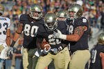 SOUTH BEND, IN - OCTOBER 29:  Cierre Wood #20 of the Notre Dame Fighting Irish celebrates a touchdown run with Tyler Eifert #80 (L) and Trevor Robinson #78 against the Navy Midshipmen at Notre Dame Stadium on October 29, 2011 in South Bend, Indiana.  Notre Dame defeated Navy 56-14. (Photo by Jonathan Daniel/Getty Images)