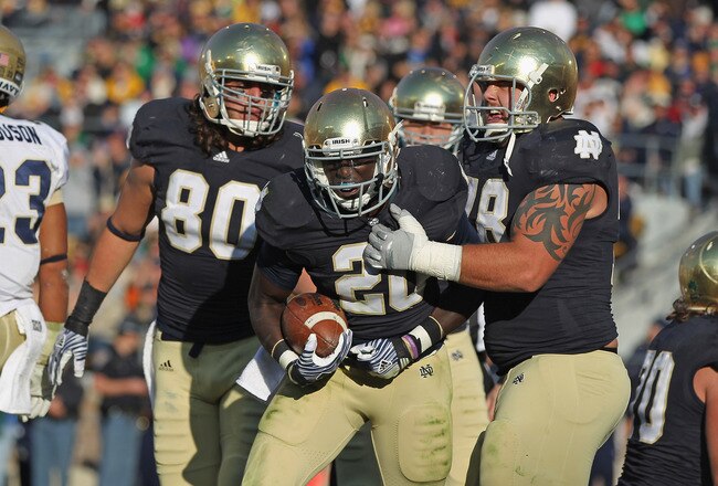 SOUTH BEND, IN - OCTOBER 29:  Cierre Wood #20 of the Notre Dame Fighting Irish celebrates a touchdown run with Tyler Eifert #80 (L) and Trevor Robinson #78 against the Navy Midshipmen at Notre Dame Stadium on October 29, 2011 in South Bend, Indiana.  Notre Dame defeated Navy 56-14. (Photo by Jonathan Daniel/Getty Images)