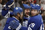 TORONTO, CANADA - NOVEMBER 19: Tim Connolly #12, John-Michael Liles #24 and Joffrey Lupul #19 of the Toronto Maple Leafs celebrate Tim Connolly's 400th career goal, against the Washington Capitals during NHL action at The Air Canada Centre November 19, 2011 in Toronto, Ontario, Canada. (Photo by Abelimages/Getty Images)