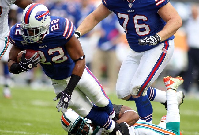 MIAMI GARDENS, FL - NOVEMBER 20:  Running back Fred Davis #22 of the Buffulo Bills is brought down by Safety Yeremiah Bell #37 of the Miami Dolphins at Sun Life Stadium on November 20, 2011 in Miami Gardens, Florida.  (Photo by Marc Serota/Getty Images)