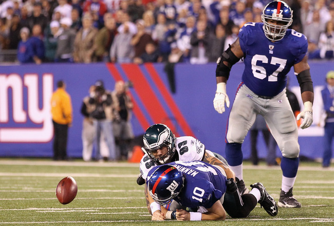 EAST RUTHERFORD, NJ - NOVEMBER 20:  Eli Manning #10 of the New York Giants fumbles the ball late in the fourth quarter against Jason Babin #93 of the Philadelphia Eagles at MetLife Stadium on November 20, 2011 in East Rutherford, New Jersey.  (Photo by Al Bello/Getty Images)