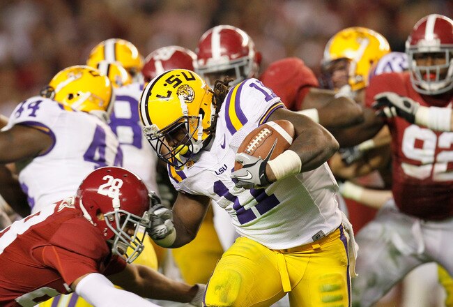 TUSCALOOSA, AL - NOVEMBER 05:  Spencer Ware #11 of the LSU Tigers gets past Dee Milliner #28 of the Alabama Crimson Tide during the game at Bryant-Denny Stadium on November 5, 2011 in Tuscaloosa, Alabama.  (Photo by Kevin C. Cox/Getty Images)