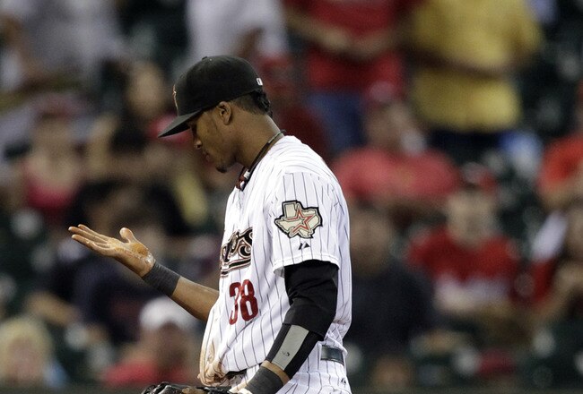 HOUSTON - SEPTEMBER 28:  Third baseman Jimmy Paredes #38 of the Houston Astros looks at his hand after he misplayed a ground ball against the St. Louis Cardinals at Minute Maid Park on September 28, 2011 in Houston, Texas.  (Photo by Bob Levey/Getty Images)