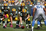 GREEN BAY, WI - OCTOBER 03: Aaron Rodgers #12 of the Green Bay Packers calls the signals as teammates Brandon Jackson #32, Korey Hall #35 and Scott Wells #63 await the snap while Landon Johnson #55 of the Detroit Lions watches at Lambeau Field on October 3, 2010 in Green Bay, Wisconsin. The Packers defeated the Lions 28-26. (Photo by Jonathan Daniel/Getty Images)