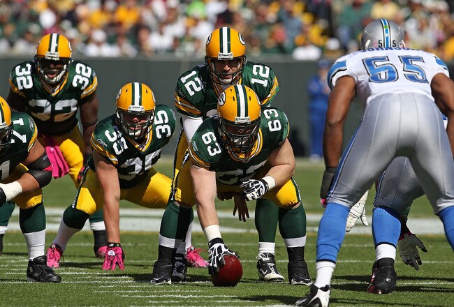 GREEN BAY, WI - OCTOBER 03: Aaron Rodgers #12 of the Green Bay Packers calls the signals as teammates Brandon Jackson #32, Korey Hall #35 and Scott Wells #63 await the snap while Landon Johnson #55 of the Detroit Lions watches at Lambeau Field on October 3, 2010 in Green Bay, Wisconsin. The Packers defeated the Lions 28-26. (Photo by Jonathan Daniel/Getty Images)
