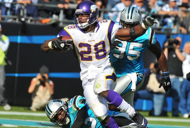 CHARLOTTE, NC - OCTOBER 30:  Running back Adrian Peterson #28 of the Minnesota Vikings runs for a nine yard touchdown in the third quarter against the Carolina Panthers October 30, 2011 at Bank of America Stadium in Charlotte, North Carolina.  The Vikings won 24 - 21. (Photo by Al Messerschmidt/Getty Images)