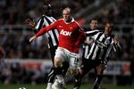 NEWCASTLE UPON TYNE, ENGLAND - APRIL 19:  Wayne Rooney of Manchester United is challenged by Cheik Tiote (L) and Danny Simpson of Newcastle United during the Barclays Premier League match between Newcastle United and Manchester United at St James' Park on April 19, 2011 in Newcastle, England.  (Photo by Clive Brunskill/Getty Images)