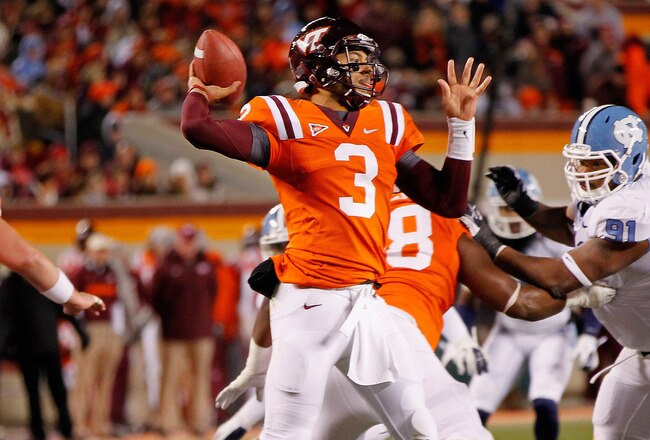 BLACKSBURG, VIRGINIA - NOVEMBER 17:  Quarterback Logan Thomas #3 of the Virginia Tech Hokies throws the ball as defensive tackle Tydreke Powell #91 of the North Carolina Tar Heels chases at Lane Stadium on November 17, 2011 in Blacksburg, Virginia. (Photo by Geoff Burke/Getty Images)