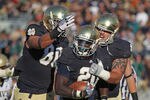 SOUTH BEND, IN - OCTOBER 29: Cierre Wood #20 of the Notre Dame Fighting Irish celebrates a touchdown run with Tyler Eifert #80 (L) and Trevor Robinson #78 against the Navy Midshipmen at Notre Dame Stadium on October 29, 2011 in South Bend, Indiana. (Photo by Jonathan Daniel/Getty Images)