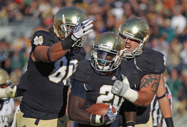 SOUTH BEND, IN - OCTOBER 29: Cierre Wood #20 of the Notre Dame Fighting Irish celebrates a touchdown run with Tyler Eifert #80 (L) and Trevor Robinson #78 against the Navy Midshipmen at Notre Dame Stadium on October 29, 2011 in South Bend, Indiana. (Photo by Jonathan Daniel/Getty Images)