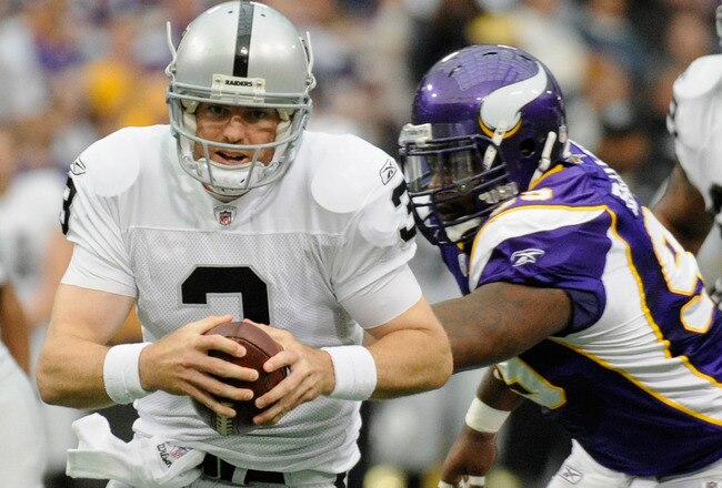 MINNEAPOLIS, MN - NOVEMBER 20: Carson Palmer #3 of the Oakland Raiders runs with the ball as Christian Ballard #99 of the Minnesota Vikings gives chase in the first quarter on November 20, 2011 at Hubert H. Humphrey Metrodome in Minneapolis, Minnesota. (Photo by Hannah Foslien/Getty Images)
