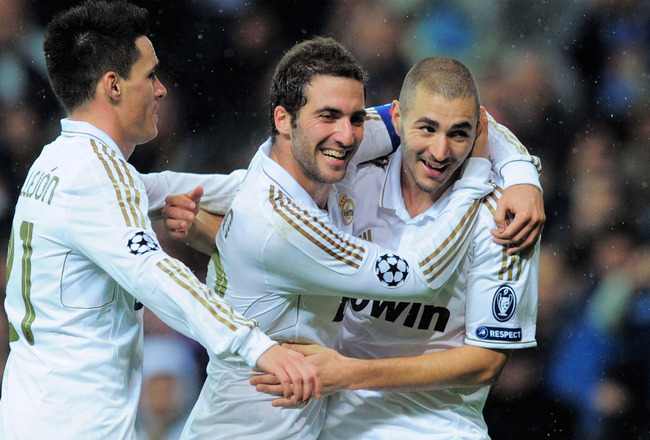 MADRID, SPAIN - NOVEMBER 22:  Karim Benzema (R) of Real Madrid celebrates with Gonzalo Higuain (C) and Jose Callejon and  after scoring his team's 6th goal  team's 6th goal during the UEFA Champions League group D match between Real Madrid and Dinamo Zagreb at Estadio Santiago Bernabeu on November 22, 2011 in Madrid, Spain.  (Photo by Denis Doyle/Getty Images)
