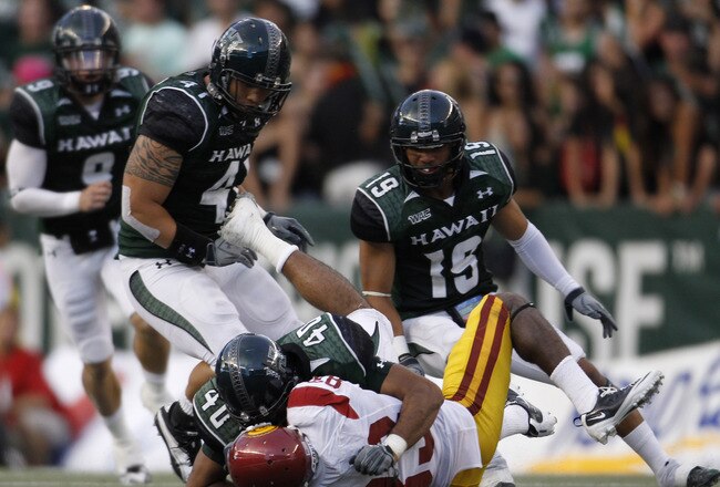 HONOLULU - SEPTEMBER 02: Ronald Johnson #83 of the University of Southern California Trojans is taken down by Po'okela Ahmad #40 of the University of Hawaii Warriors during first half action against the University of Southern California Trojans at Aloha Stadium September 2, 2010 in Honolulu, Hawaii. (Photo by Kent Nishimura/Getty Images)