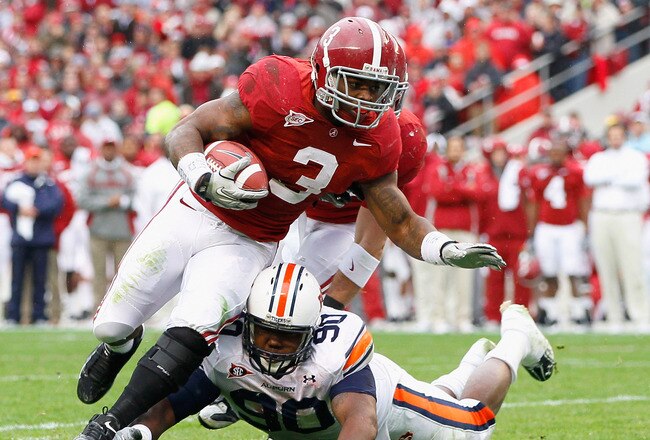 TUSCALOOSA, AL - NOVEMBER 26:  Trent Richardson #3 of the Alabama Crimson Tide is tackled by Nick Fairly #90 of the Auburn Tigers at Bryant-Denny Stadium on November 26, 2010 in Tuscaloosa, Alabama.  (Photo by Kevin C. Cox/Getty Images)