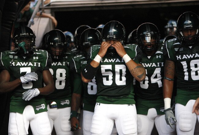 HONOLULU - SEPTEMBER 02: Mana Lolotai #50 of the University of Hawaii Warriors checks his helmet before the Warriors take the field in their season opener against the University of Southern California Trojans at Aloha Stadium September 2, 2010 in Honolulu, Hawaii. (Photo by Kent Nishimura/Getty Images)