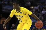 CHARLOTTE, NC - MARCH 20:  Tim Hardaway Jr. #10 of the Michigan Wolverines moves the ball while taking on the Duke Blue Devils during the third round of the 2011 NCAA men's basketball tournament at Time Warner Cable Arena on March 20, 2011 in Charlotte, North Carolina.  (Photo by Streeter Lecka/Getty Images)