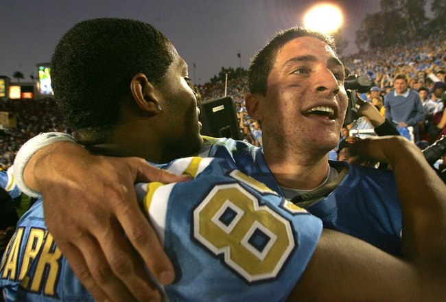 PASADENA, CA - DECEMBER 2:  Quarterback Patrick Cowan #12 (R) of the UCLA Bruins hugs defensive end David Carter #85 after their win over the USC Trojans on December 2, 2006 at the Rose Bowl in Pasadena, California. The UCLA Bruins defeated the USC Trojans 13-9.  (Photo by Stephen Dunn)