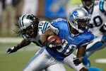 DETROIT, MI - NOVEMBER 20:  Kevin Smith #30 of the Detroit Lions gets around Charles Godfrey #30 of the Carolina Panthers for a fourth quarter touchdown at Ford Field on November 20, 2011 in Detroit, Michigan. Detroit won the game 49-35. (Photo by Gregory Shamus/Getty Images)