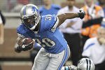 DETROIT - NOVEMBER 20: Kevin Smith #30 of the Detroit Lions runs for a first down during the third quarter as James Anderson #50 of the Carolina Panthers attempts to make the stop during the game at Ford Field on November 20, 2011 in Detroit, Michigan. The Lions defeated the Panthers 49-35.  (Photo by Leon Halip/Getty Images)