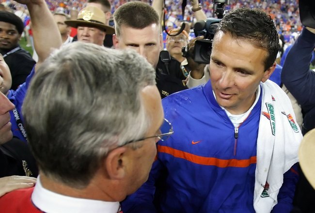 GLENDALE, AZ - JANUARY 08:  (R-L) Head coach Urban Meyer of the Florida Gators shakes hands with head coach Jim Tressel of the Ohio State Buckeyes after the 2007 Tostitos BCS National Championship Game at the University of Phoenix Stadium on January 8, 2007 in Glendale, Arizona. The Gators defeated the Buckeyes 41-14.  (Photo by Jed Jacobsohn/Getty Images)
