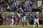 DETROIT - NOVEMBER 25:  Calvin Johnson #81 of the Detroit Lions celebrates a first quarter touchdown with teammate Brandon Pettigrew #84 to give the Lions a 7-3 lead over the New England Patriots at Ford Field on November 25, 2010 in Detroit, Michigan.  (Photo by Leon Halip/Getty Images)