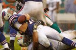 MIAMI GARDENS, FL - NOVEMBER 20:  Ryan Fitzpatrick #14 of the Buffalo Bills is sacked by Jared Odrick #98 of the Miami Dolphins during a game  at Sun Life Stadium on November 20, 2011 in Miami Gardens, Florida.  (Photo by Mike Ehrmann/Getty Images)