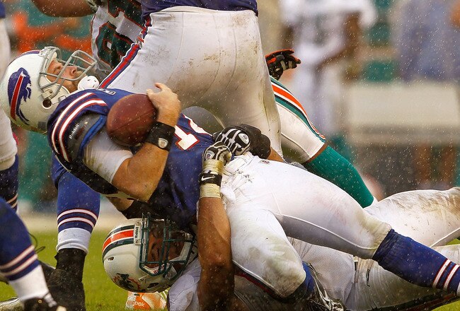 MIAMI GARDENS, FL - NOVEMBER 20:  Ryan Fitzpatrick #14 of the Buffalo Bills is sacked by Jared Odrick #98 of the Miami Dolphins during a game  at Sun Life Stadium on November 20, 2011 in Miami Gardens, Florida.  (Photo by Mike Ehrmann/Getty Images)