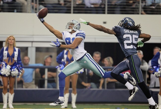 ARLINGTON, TX - NOVEMBER 06:  Wide receiver Laurent Robinson #81 of the Dallas Cowboys lunges but can't make a catch while being pursued by Richard Sherman #25 of the Seattle Seahawks in the second half at Cowboys Stadium on November 6, 2011 in Arlington, Texas. The Cowboys defeated the Seahawks 23-13.  (Photo by Jeff Gross/Getty Images)