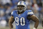 DETROIT - NOVEMBER 20: Ndamukong Suh #90 of the Detroit Lions checks the defense during the game against the Carolina Panthers at Ford Field on November 20, 2011 in Detroit, Michigan. The Lions defeated the Panthers 49-35.  (Photo by Leon Halip/Getty Images)