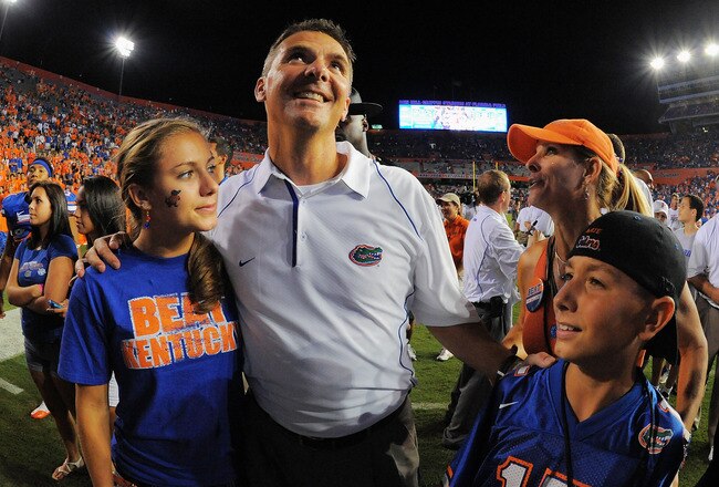 GAINESVILLE, FL - SEPTEMBER 25:  Head coach Urban Meyer of the Florida Gators celebrates with his wife Shelley Meyers and children Gigi Meyers, L, and Nate Meyers, R, after defeating the Kentucky Wildcats at Ben Hill Griffin Stadium on September 25, 2010 in Gainesville, Florida. Florida defeated Kentucky 48-14 for Meyer's 100th career victory.  (Photo by Doug Benc/Getty Images)