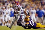 BATON ROUGE, LA - NOVEMBER 14:  Tyrone Duplessis #22 of the Louisiana Tech Bulldogs is brought down by Perry Riley #56 of the LSU Tigers at Tiger Stadium on November 14, 2009 in Baton Rouge, Louisiana.  (Photo by Chris Graythen/Getty Images)