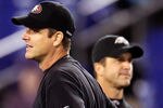 BALTIMORE, MD - NOVEMBER 24:  Head coach Jim Harbaugh (L) of the San Francisco 49ers and his brother, head coach John Harbaugh (R) of the Baltimore Ravens stand next to each other before the start of their game at M&T Bank Stadium on November 24, 2011 in Baltimore, Maryland.  (Photo by Rob Carr/Getty Images)