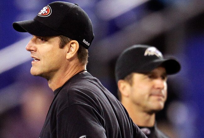 BALTIMORE, MD - NOVEMBER 24:  Head coach Jim Harbaugh (L) of the San Francisco 49ers and his brother, head coach John Harbaugh (R) of the Baltimore Ravens stand next to each other before the start of their game at M&T Bank Stadium on November 24, 2011 in Baltimore, Maryland.  (Photo by Rob Carr/Getty Images)