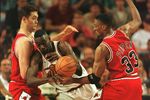 14 Jun 1996: Scottie Pippen #33 of the Chicago Bulls knocks the ball away from Shawn Kemp of the Seattle Supersonics with help from teammate Luc Longley (left) during the second half of the Sonics 89-78 victory over the Bulls in game five of the NBA Final