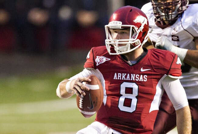 LITTLE ROCK, AR - NOVEMBER 19:   Quarterback Tyler Wilson #8 of the Arkansas Razorbacks slides to ground after running the ball against the Mississippi State Bulldogs at War Memorial Stadium on November 19, 2011 in Little Rock, Arkansas. The Razorbacks defeated the Bulldogs 44-17.  (Photo by Wesley Hitt/Getty Images)