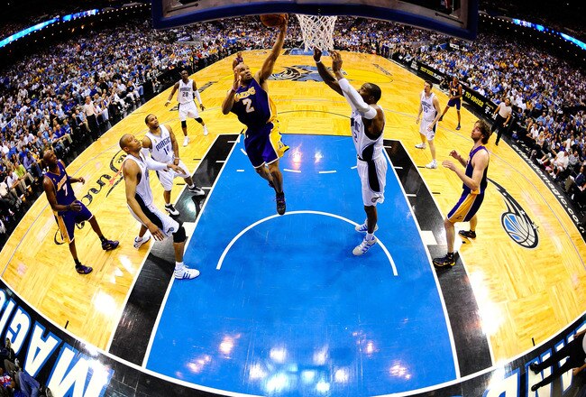 ORLANDO, FL - JUNE 11:  Derek Fisher #2 of the Los Angeles Lakers goes up for a shot against Dwight Howard #12 of the Orlando Magic in Game Four of the 2009 NBA Finals on June 11, 2009 at Amway Arena in Orlando, Florida.  NOTE TO USER:  User expressly acknowledges and agrees that, by downloading and or using this photograph, User is consenting to the terms and conditions of the Getty Images License Agreement.  (Photo by Larry W. Smith/Getty Images)