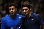 LONDON, ENGLAND - NOVEMBER 20:  Jo-Wilfried Tsonga of France reacts next to Roger Federer of Switzerland after the men's singles first round match at the Barclays ATP World Tour Finals at the O2 Arena on November 20, 2011 in London, England.  (Photo by Clive Brunskill/Getty Images)