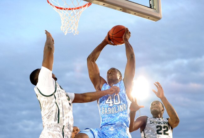 SAN DIEGO, CA - NOVEMBER 11:  Harrison Barnes #40 of the North Carolina Tar Heels goes up for a shot against Derrick Nix #25 and Branden Dawson #22 of the Michigan State Spartans in the first half during the NCAA men's college basketball Carrier Classic aboard the flight deck of the USS Carl Vinson on November 11, 2011 in San Diego, California.  (Photo by Harry How/Getty Images)