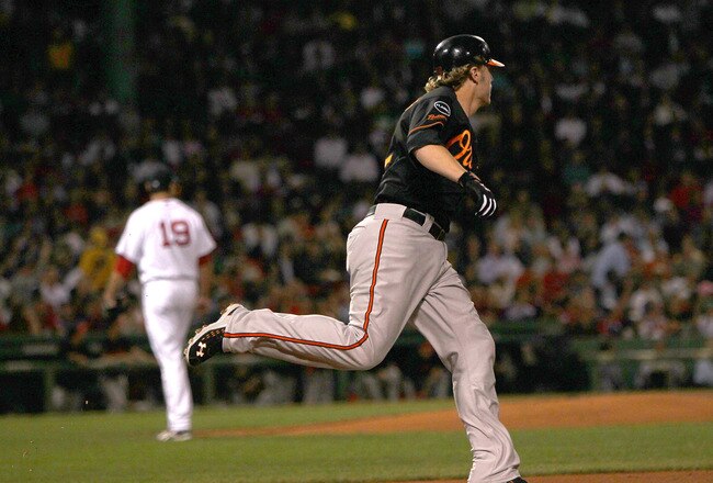 BOSTON, MA - SEPTEMBER 21:  Mark Reynolds #12 of the Baltimore Orioles rounds the bases after a home run as Josh Beckett #19 of the Boston Red Sox regroups at Fenway Park September 21, 2011 in Boston, Massachusetts. (Photo by Jim Rogash/Getty Images)