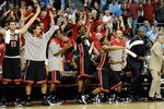 LAS VEGAS, NV - NOVEMBER 26:  Players and coaches on the UNLV Rebels bench react late in the team's 90-80 win over the North Carolina Tar Heels in the championship game of the Continental Tire Las Vegas Invitational at the Orleans Arena November 26, 2011 in Las Vegas, Nevada.  (Photo by Ethan Miller/Getty Images)