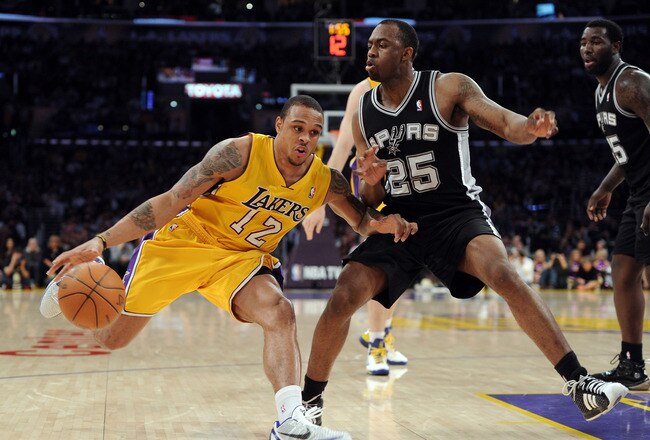 LOS ANGELES, CA - APRIL 12:  Shannon Brown #12 of the Los Angeles Lakers dribbles on James Anderson #25 of the San Antonio Spurs during the game at Staples Center on April 12, 2011 in Los Angeles, California.  NOTE TO USER: User expressly acknowledges and agrees that, by downloading and or using this photograph, User is consenting to the terms and conditions of the Getty Images License Agreement.  (Photo by Harry How/Getty Images)