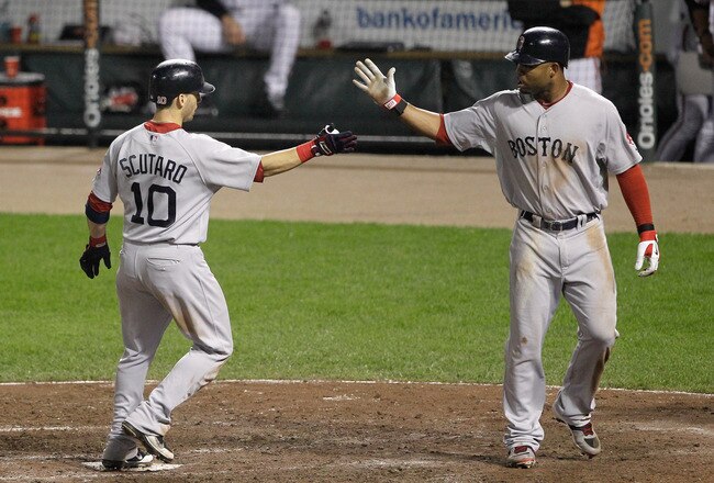 BALTIMORE, MD - SEPTEMBER 27: Marco Scutaro #10 of the Boston Red Sox is congratulated by Carl Crawford #13 (R) after driving him in on a two RBI home run during the sixth inning against the Baltimore Orioles at Oriole Park at Camden Yards on September 27, 2011 in Baltimore, Maryland.  (Photo by Rob Carr/Getty Images)