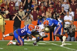GAINESVILLE, FL - NOVEMBER 26:  Linebacker Telvin Smith #22 of the Florida State Seminoles breaks through a block of center Jonotthan Harrison #72 to tackle running back Chris Rainey #1 of the Florida Gators November 26, 2011 at Ben Hill Griffin Stadium in Gainesville, Florida.  (Photo by Al Messerschmidt/Getty Images)