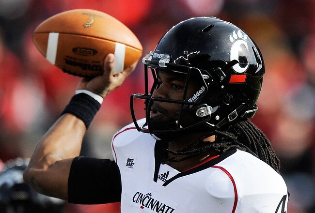 NEW BRUNSWICK, NJ - NOVEMBER 19:  Munchie Legaux #4 of the Cincinnati Bearcats throws a pass against the Rutgers Scarlet Knights at Rutgers Stadium on November 19, 2011 in New Brunswick, New Jersey.  (Photo by Patrick McDermott/Getty Images)