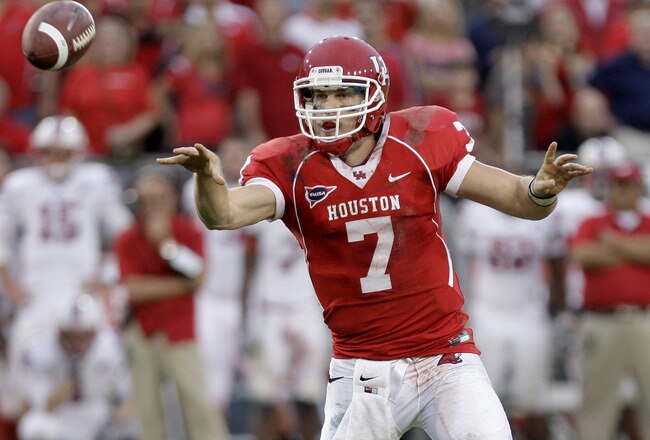 HOUSTON, TX - NOVEMBER 19: Quarterback Case Keenum #7 of the Houston Cougars throws a touch pass for a touchdown against  Southern Methodist University Mustangs on November 19, 2011 at Robertson Stadium in Houston, Texas. Houston defeated SMU 37-7.  (Photo by Thomas B. Shea/Getty Images)