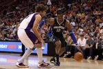 PHOENIX, AZ - MARCH 13:  Dwight Howard #12 of the Orlando Magic drives to the basket during the NBA game against the Phoenix Suns at US Airways Center on March 13, 2011 in Phoenix, Arizona. The Magic defeated the Suns 111-88. NOTE TO USER: User expressly acknowledges and agrees that, by downloading and or using this photograph, User is consenting to the terms and conditions of the Getty Images License Agreement.  (Photo by Christian Petersen/Getty Images)