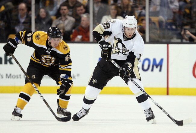 BOSTON, MA - MARCH 05: James Neal #18 of the Pittsburgh Penguins takes the puck as Brad Marchand #63 of the Boston Bruins defends on March 5, 2011 at the TD Garden in Boston, Massachusetts.  (Photo by Elsa/Getty Images)