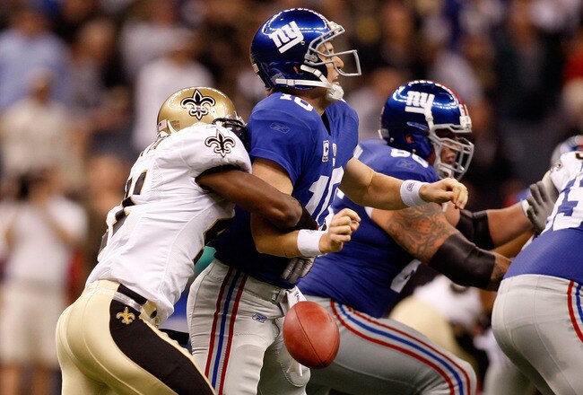 NEW ORLEANS - OCTOBER 18:  Roman Harper #41 of the New Orleans Saints forces a fumble by quarterback Eli Manning #10 of the New York Giants at the Louisiana Superdome on October 18, 2009 in New Orleans, Louisiana.  (Photo by Chris Graythen/Getty Images)